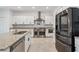 Bright kitchen featuring stainless steel appliances, granite countertops, and modern white cabinetry at 11105 Balfour E St, Venice, FL 34293