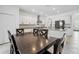 Eat-in kitchen with granite counters, stainless appliances, and white cabinetry at 11105 Balfour E St, Venice, FL 34293