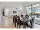 Open-concept living space with a dining area and access to the pool through sliding doors at 11105 Balfour E St, Venice, FL 34293