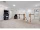 Upstairs loft boasts plush carpeting, a gaming console, and staircase with wooden handrail at 11105 Balfour E St, Venice, FL 34293