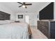 Comfortable main bedroom with a king-size bed, ceiling fan, and adjacent ensuite bathroom at 11105 Balfour E St, Venice, FL 34293