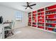 Inviting home office featuring a built-in bookcase and a comfortable workspace with natural light at 11105 Balfour E St, Venice, FL 34293