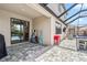 The covered patio with decorative pavers provides easy access to the luxurious screened pool at 11105 Balfour E St, Venice, FL 34293