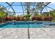 Screened-in pool with basketball hoop and waterfall features, offering a luxurious backyard experience at 11105 Balfour E St, Venice, FL 34293