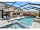 The screened in pool features sun loungers, comfortable seating, and a pool table at 11105 Balfour E St, Venice, FL 34293