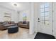 Cozy sitting area with two couches, ottoman, and a large window providing natural light on tile flooring at 11105 Balfour E St, Venice, FL 34293
