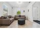 Cozy sitting area with two couches, ottoman, and a large window providing natural light on tile flooring at 11105 Balfour E St, Venice, FL 34293