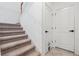 Carpeted staircase with white walls and trim offers access to other levels of the home at 11105 Balfour E St, Venice, FL 34293