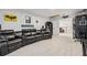 Home theater room featuring reclining leather seating, movie memorabilia, and stylish decor at 11105 Balfour E St, Venice, FL 34293