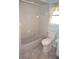 A compact bathroom featuring a shower-tub combo, toilet, and window with curtain at 1128 Rum Cay Ct, Punta Gorda, FL 33950