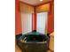 Garden tub is surrounded by marble countertops and the windows have decorative valances at 1128 Rum Cay Ct, Punta Gorda, FL 33950