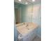 Bathroom with a vanity, marble countertop, large mirror, and white cabinets at 1128 Rum Cay Ct, Punta Gorda, FL 33950