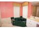 A bathroom featuring a corner bathtub, vanity with sink and decorative wallpaper at 1128 Rum Cay Ct, Punta Gorda, FL 33950