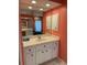 Bathroom vanity with sink, drawers, and white cabinets with a large mirror at 1128 Rum Cay Ct, Punta Gorda, FL 33950