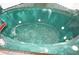 A close-up of a green corner jacuzzi tub at 1128 Rum Cay Ct, Punta Gorda, FL 33950