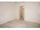 An unfurnished bedroom with a carpeted floor and an open closet with shelves at 1128 Rum Cay Ct, Punta Gorda, FL 33950