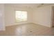 Bedroom featuring neutral tile flooring, large window, and a ceiling fan at 1128 Rum Cay Ct, Punta Gorda, FL 33950