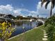 Waterfront view of the canal featuring boat docks and lush landscaping at 1128 Rum Cay Ct, Punta Gorda, FL 33950