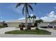 Charming single-story home with a well-manicured lawn, beautiful palms and a circular driveway at 1128 Rum Cay Ct, Punta Gorda, FL 33950