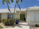 Inviting home entrance featuring double front doors, stone pathway, and attractive landscaping at 1128 Rum Cay Ct, Punta Gorda, FL 33950