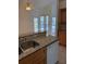 Kitchen bar area overlooking screened-in lanai with swimming pool and plenty of natural light at 1128 Rum Cay Ct, Punta Gorda, FL 33950
