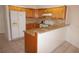 Kitchen with stone countertops, wood cabinets, and white appliances at 1128 Rum Cay Ct, Punta Gorda, FL 33950