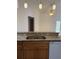 Kitchen area with stainless steel sink and breakfast bar; view of high ceilings and fan at 1128 Rum Cay Ct, Punta Gorda, FL 33950