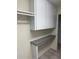Functional laundry room with overhead cabinets and a built-in folding counter at 1128 Rum Cay Ct, Punta Gorda, FL 33950