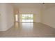 Bright living room with neutral tile floors, ceiling fan and sliding doors leading to the screened patio at 1128 Rum Cay Ct, Punta Gorda, FL 33950