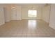 Open living room with neutral tile floors, ceiling fan and window at 1128 Rum Cay Ct, Punta Gorda, FL 33950