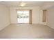 A bright living room with sliding glass doors and backyard pool view at 1128 Rum Cay Ct, Punta Gorda, FL 33950