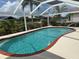 Refreshing backyard swimming pool surrounded by a well-maintained yard and a screened enclosure at 1128 Rum Cay Ct, Punta Gorda, FL 33950
