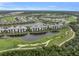 Stunning aerial view of a community with condos, lakes, a golf course, and lush landscaping at 14081 Heritage Landing Blvd # 214, Punta Gorda, FL 33955