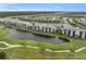 Beautiful aerial view of lakeside condos surrounded by a lush golf course and mature trees at 14081 Heritage Landing Blvd # 214, Punta Gorda, FL 33955