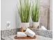 Close-up shot of bathroom countertop with decorative plants, towels, and granite countertop at 14081 Heritage Landing Blvd # 214, Punta Gorda, FL 33955