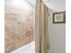 Bathtub with neutral tile, and beige curtain at 14081 Heritage Landing Blvd # 214, Punta Gorda, FL 33955
