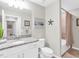 Bathroom featuring granite countertops, white cabinets, a sink, and a toilet at 14081 Heritage Landing Blvd # 214, Punta Gorda, FL 33955