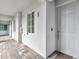 Apartment exterior with hallway featuring a door, window, and exterior lighting fixture at 14081 Heritage Landing Blvd # 214, Punta Gorda, FL 33955