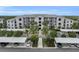 Exterior of a modern apartment complex with well-maintained landscaping and ample parking at 14081 Heritage Landing Blvd # 214, Punta Gorda, FL 33955