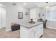 Well-lit kitchen area with granite countertops and a view of the entryway with sitting bench and decor at 14081 Heritage Landing Blvd # 214, Punta Gorda, FL 33955