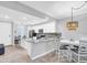 Bright kitchen featuring an island with granite countertops, white cabinets, and stainless steel appliances at 14081 Heritage Landing Blvd # 214, Punta Gorda, FL 33955