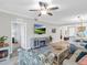 Cozy living room with fireplace, TV, and view of dining area and entryway at 14081 Heritage Landing Blvd # 214, Punta Gorda, FL 33955