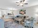 Bright living room with open floor plan, stylish furnishings, and a coastal-themed decor at 14081 Heritage Landing Blvd # 214, Punta Gorda, FL 33955