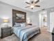 Stylish main bedroom featuring a wood accent wall and en-suite bathroom at 14081 Heritage Landing Blvd # 214, Punta Gorda, FL 33955