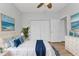 Bright bedroom with ocean-themed decor, ample closet space, and wood-look floors at 1605 Palace Ct, Punta Gorda, FL 33980