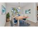 Cozy dining area with a rustic wood table, upholstered chairs, a window with a tropical view and stylish decor at 1605 Palace Ct, Punta Gorda, FL 33980