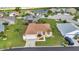 Inviting single-story home showcasing a manicured lawn, palm trees, and attached garage, set within a serene community at 1605 Palace Ct, Punta Gorda, FL 33980