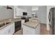 Bright kitchen with white cabinets, stainless steel appliances, an island and granite countertops at 1605 Palace Ct, Punta Gorda, FL 33980