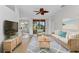 Comfortable living room features a cozy sofa, stylish rug, ceiling fan, and sliding glass doors to the backyard at 1605 Palace Ct, Punta Gorda, FL 33980