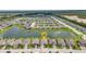 Aerial view of homes in the community overlooking a pond with easy access to amenities at 16848 Canopy Garden Dr, Port Charlotte, FL 33953